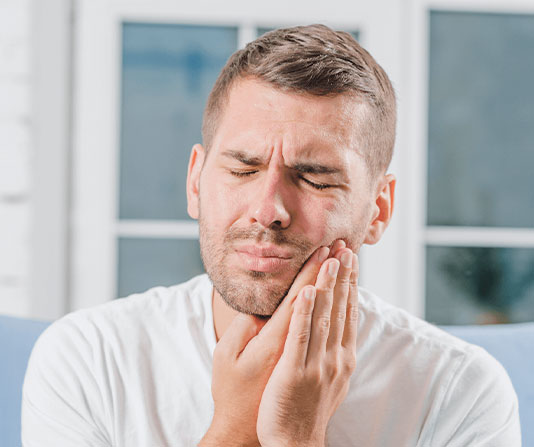 Man is suffering from a tooth pain